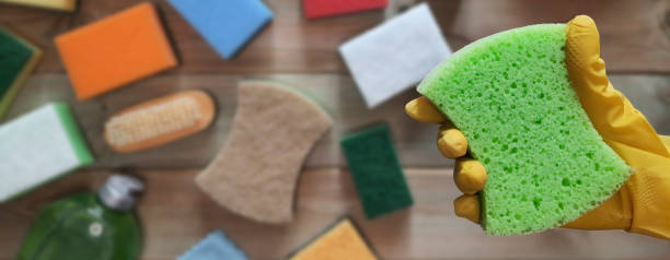istock Banner with hand in rubber glove with kitchen cleaning sponge. 1489865910