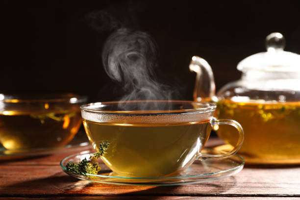 istock Cup of aromatic herbal tea and thyme on wooden table 1489867352