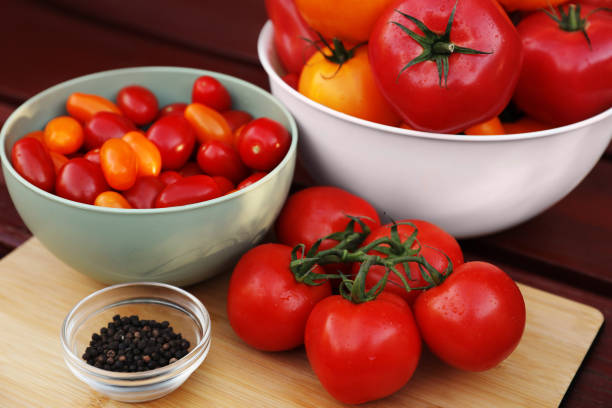 istock Bowls with fresh tomatoes and spices on wooden table 1489867413