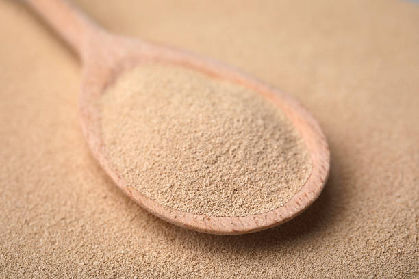 istock Spoon with granulated yeast, closeup view. Ingredient for baking 1489867504