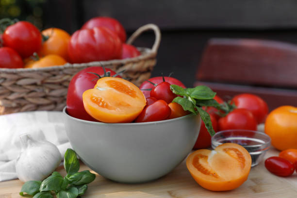 Red and green fresh tomatoes in cup.