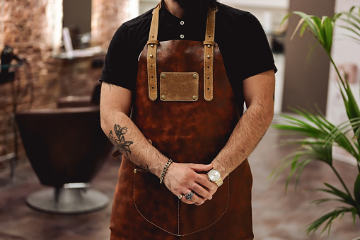 Craftsperson, in a leather apron.