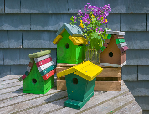 Small decor wooden bird houses boxes and Easter decorations hanging on tree branches