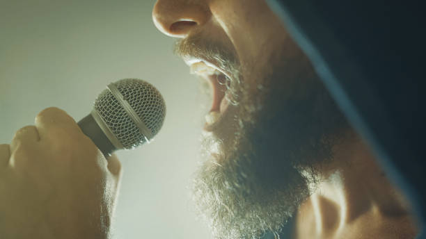 istock Rock singer screaming in a live show with stage lights 1489886165