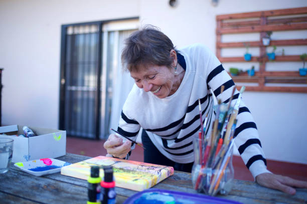 istock woman painting on a canvas 1489890151