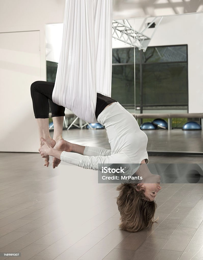 AntiGravity Yoga Woman doing anti gravity yoga exercise in fitness center. 30-34 Years Stock Photo