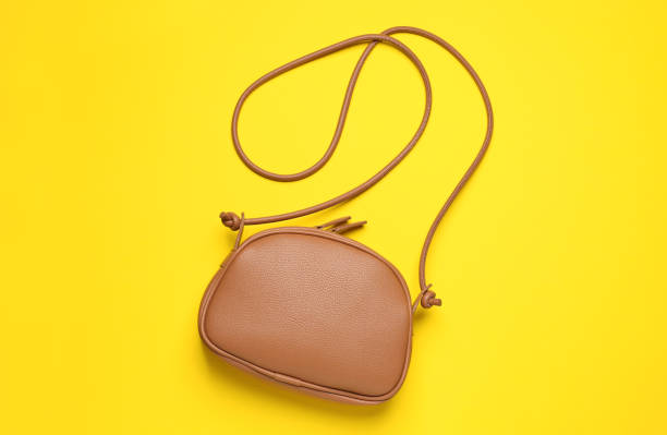 istock Stylish leather handbag on yellow background, top view 1489899863