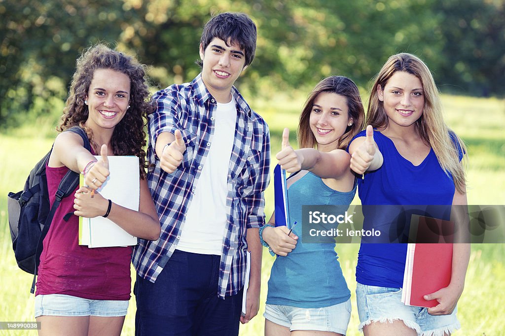 Young group of happy students showing thumbs up sign together Young group of happy students showing thumbs up sign together outdoor in the park Italy Activity Stock Photo