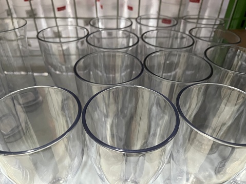Top view of many simple drinking glasses in a department store for sale.