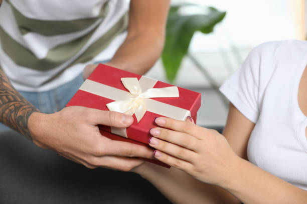 istock Lovely couple with beautiful gift, closeup view 1489905041