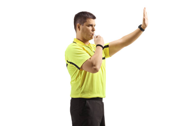 istock Football referee blowing a whistle and gesturing stop 1489906495