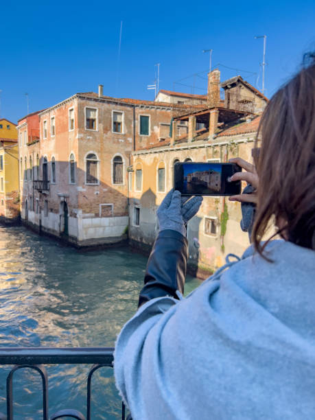 istock Tourist taking picture with mobile phone, rear view 1489912397