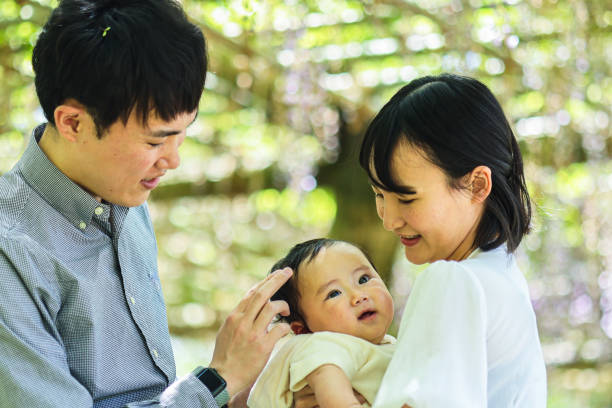 istock Parents and their baby in park 1489914379