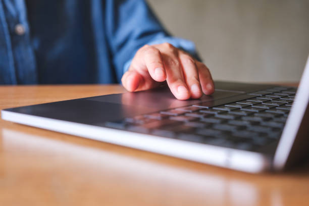 istock Closeup image of a woman working and touching on laptop computer touchpad 1489923330
