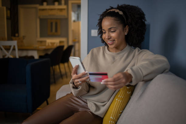 istock Cheerful  woman doing online shopping 1489926652