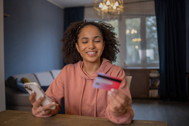 istock Cheerful  woman doing online shopping 1489926657