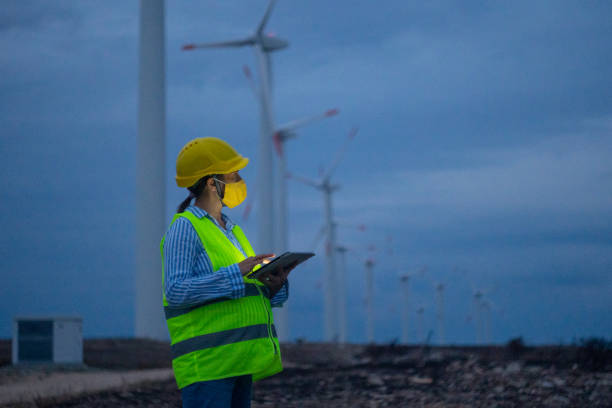 istock Pregnant wind energy engineer working late at wind farm. 1489926765