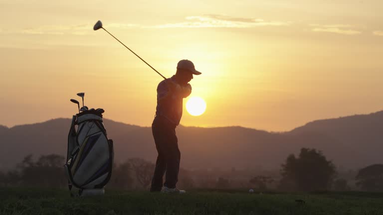 Male golfer teeing off on fairway at sunset ,layout beauty and player exercise to good health.