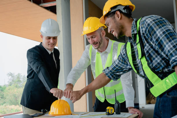 istock multi ethnic engineer brainstorming with deal and measuring for cost estimating on paperworks and floor plan drawings, contract and agreement concepts 1489929467