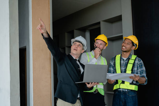 istock multi ethnic engineer brainstorming and measuring for cost estimating on blueprint and floor plan drawings about design architectural and engineering for houses and buildings 1489929700