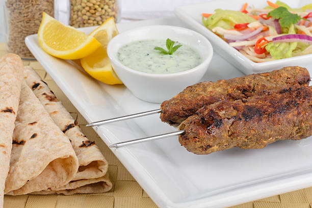 istock 2 seekh kebabs on a white square plate 148992997