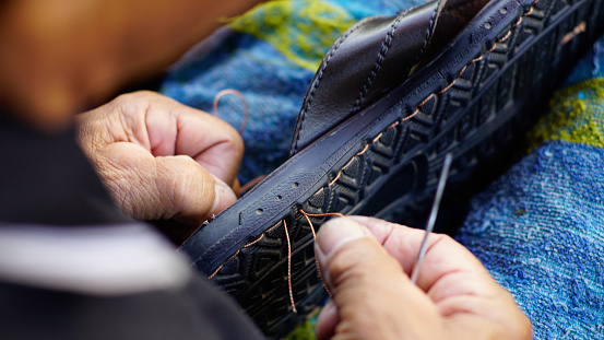 old sandals are re-stitched by hand using nylon thread.