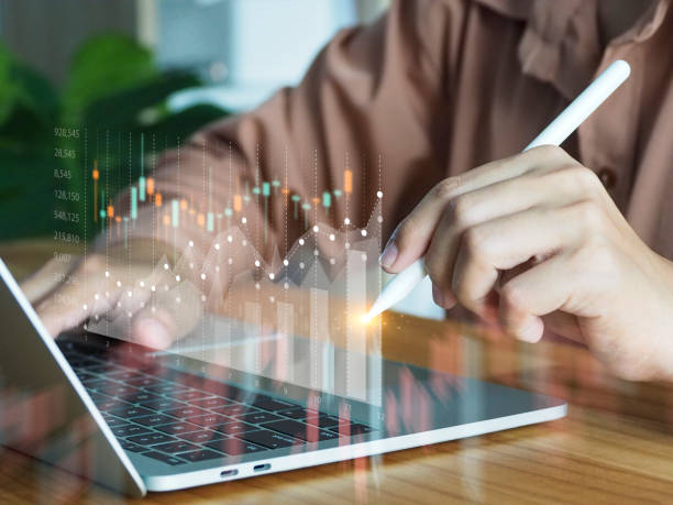 istock business people analyzing graphs investing in stocks 1489932801