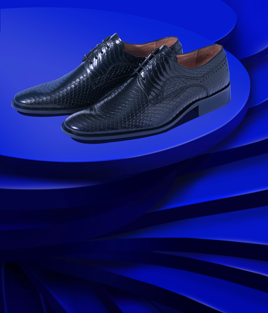 Chic man leather dress shoes in a chic blue layered background