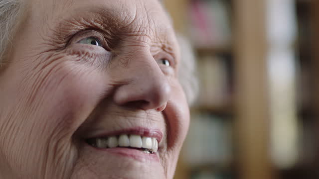 close up portrait of happy elderly caucasian woman smiling cheerful positive looking up