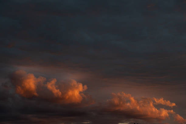 Orange and red cloudy sky at dusk in spring. Bas-Rhin, Collectivite europeenne d'Alsace,Grand Est, France.