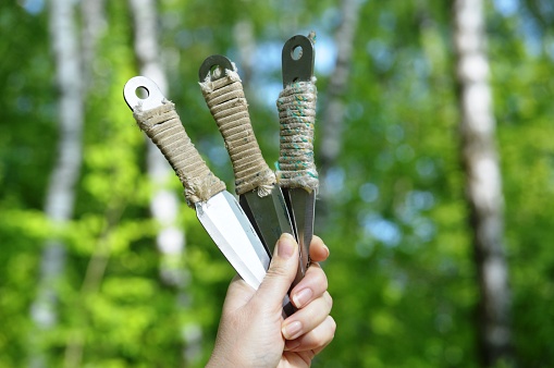 sports throwing knives in the hands of an athlete