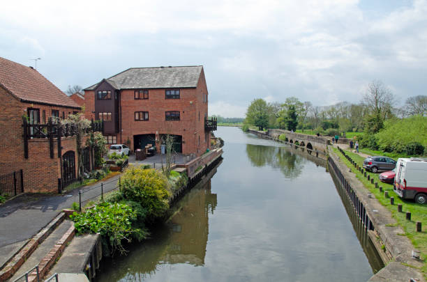 istock Old brick warehouses converted into lofts along a river on a sunny autumn day. 1489954276