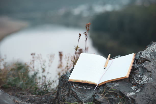 istock an open paper diary with a fountain pen on an old stone covered with moss 1489957433