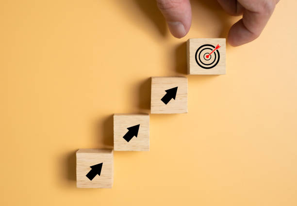 istock Selective focus at wood brick with icon of target customer with arrow pointing on target. SEO tools which can increase sale and revenue. Marketing icon concept on plain background with copy space. 1489960743