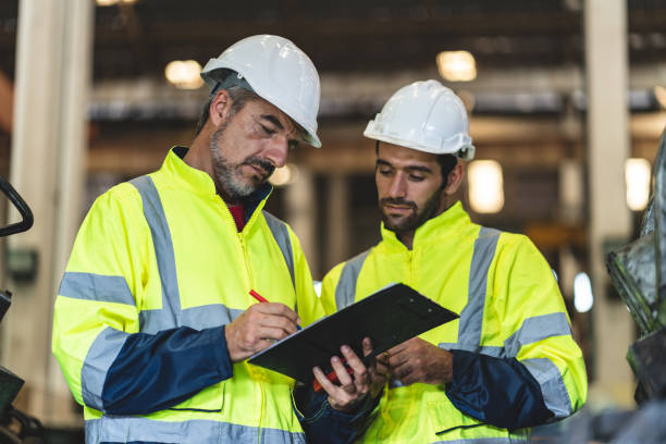 istock professional technician engineer with safety helmet hard hat working in industrial manufacturing factory, men at work to checking equipment of machinery production technology or construction operating 1489963688