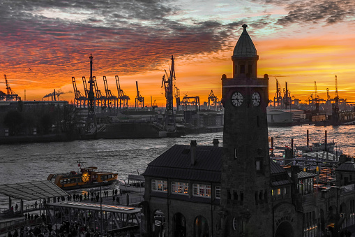 View of the level tower at the Landungsbrücken and the port of Hamburg during sunset, horizontal