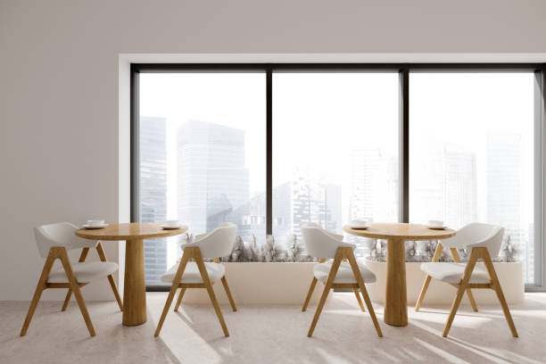 istock White cafe interior with two wooden tables and seats, panoramic window 1489971492