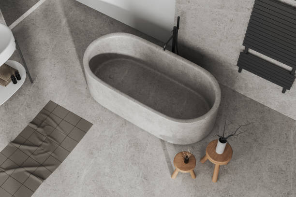 istock Top view of light concrete bathroom interior with bathtub and accessories 1489971911