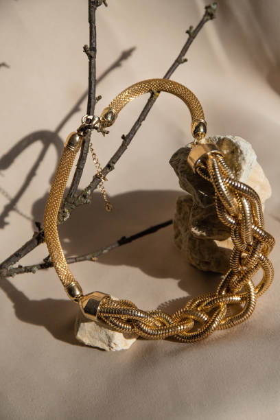 istock Still life with golden necklace over beige background. Minimalistic abstract composition. 1489973617