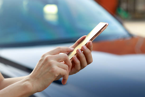 istock A young Asian businesswoman walks to her car while using her smartphone, representing the concept of doing business on the go. 1489974970