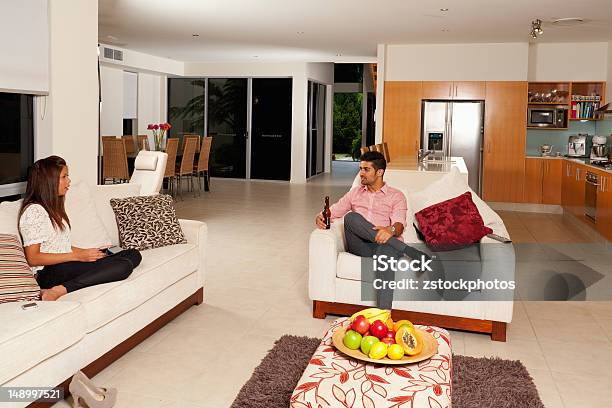 Young Couple In Living Room Stock Photo - Download Image Now - Kitchen, West Asian Ethnicity, Adult