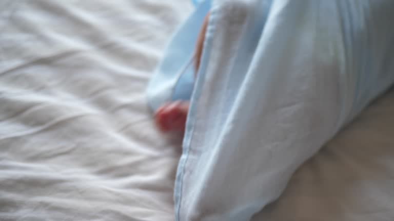 Newborn infant baby little legs and feet when he lying on bad in nappy