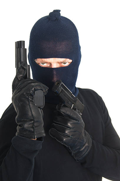 istock Masked terrorist with two guns - isolated on white 148997884
