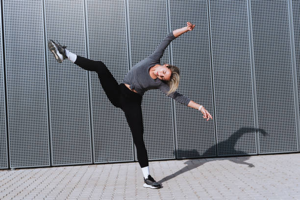 istock Expressive woman dancer performing against  background with modern steel panels 1489980003