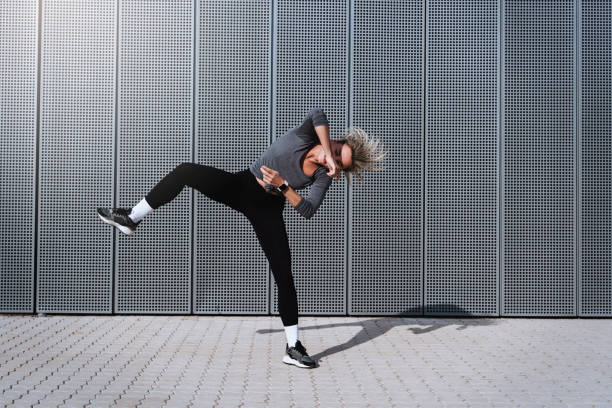 istock Expressive woman dancer performing against  background with modern steel panels 1489980036