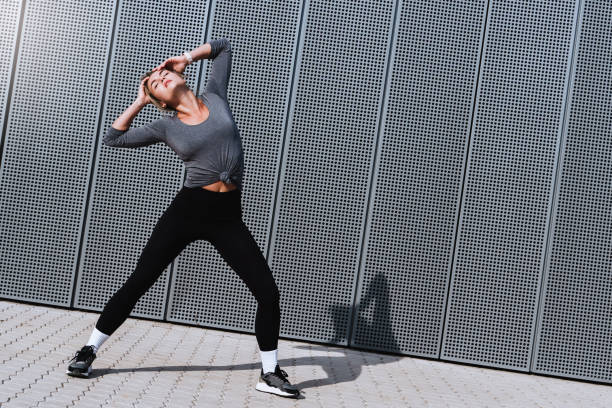 istock Expressive woman dancer performing against  background with modern steel panels 1489980057