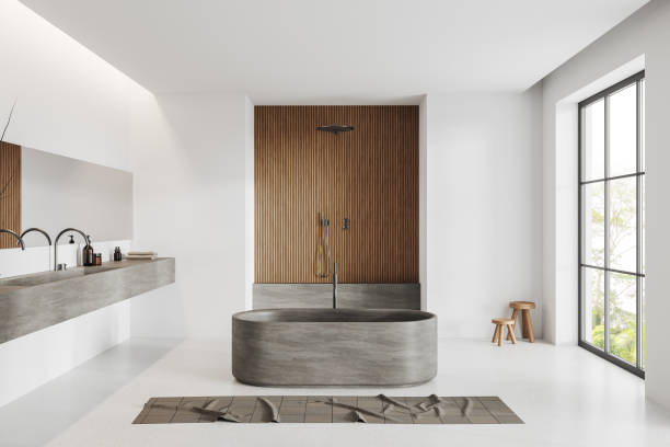 istock White bathroom interior with double sink, douche and tub near panoramic window 1489982465