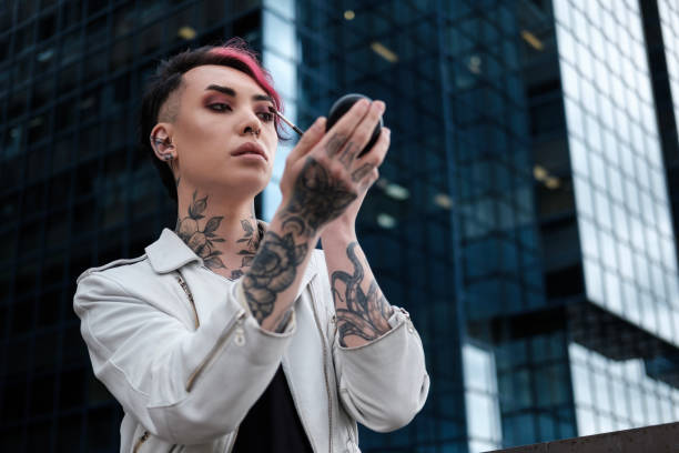 istock Portrait of non-binary male doing himself makeup outdoors. 1489982647