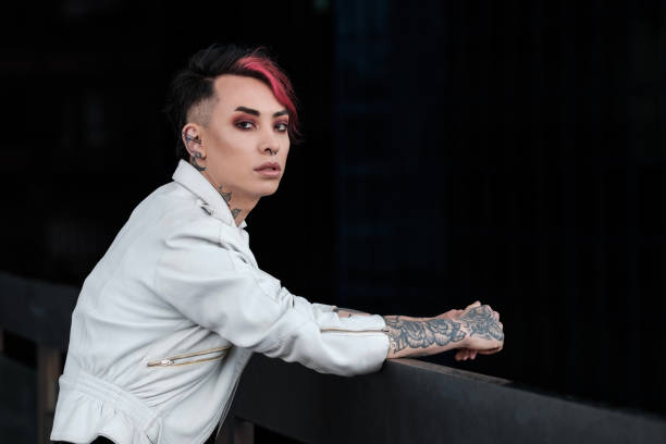 istock Portrait of relaxed androgynous non-binary male leaning on banister. 1489982662