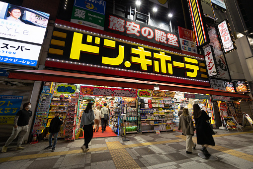 Tokyo, Japan - November 28, 2022 : Pedestrians walk past the Don Quijote Store in Ikebukuro, Tokyo, Japan. It is a famous Japanese discount store chain.